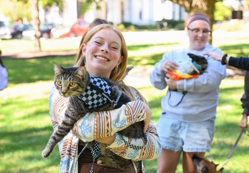 Student holding cat