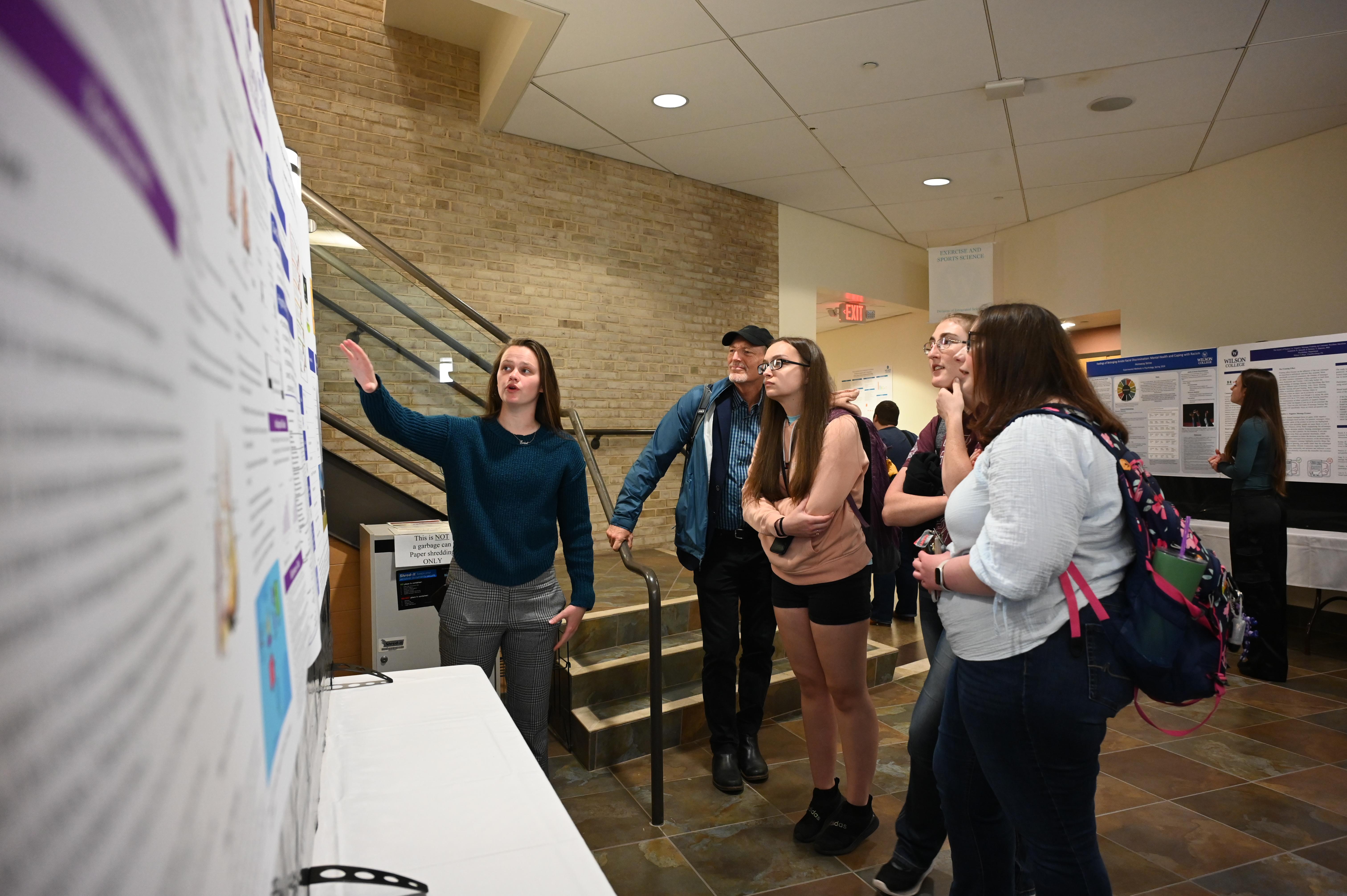 Students looking at a poster at Student Research Day