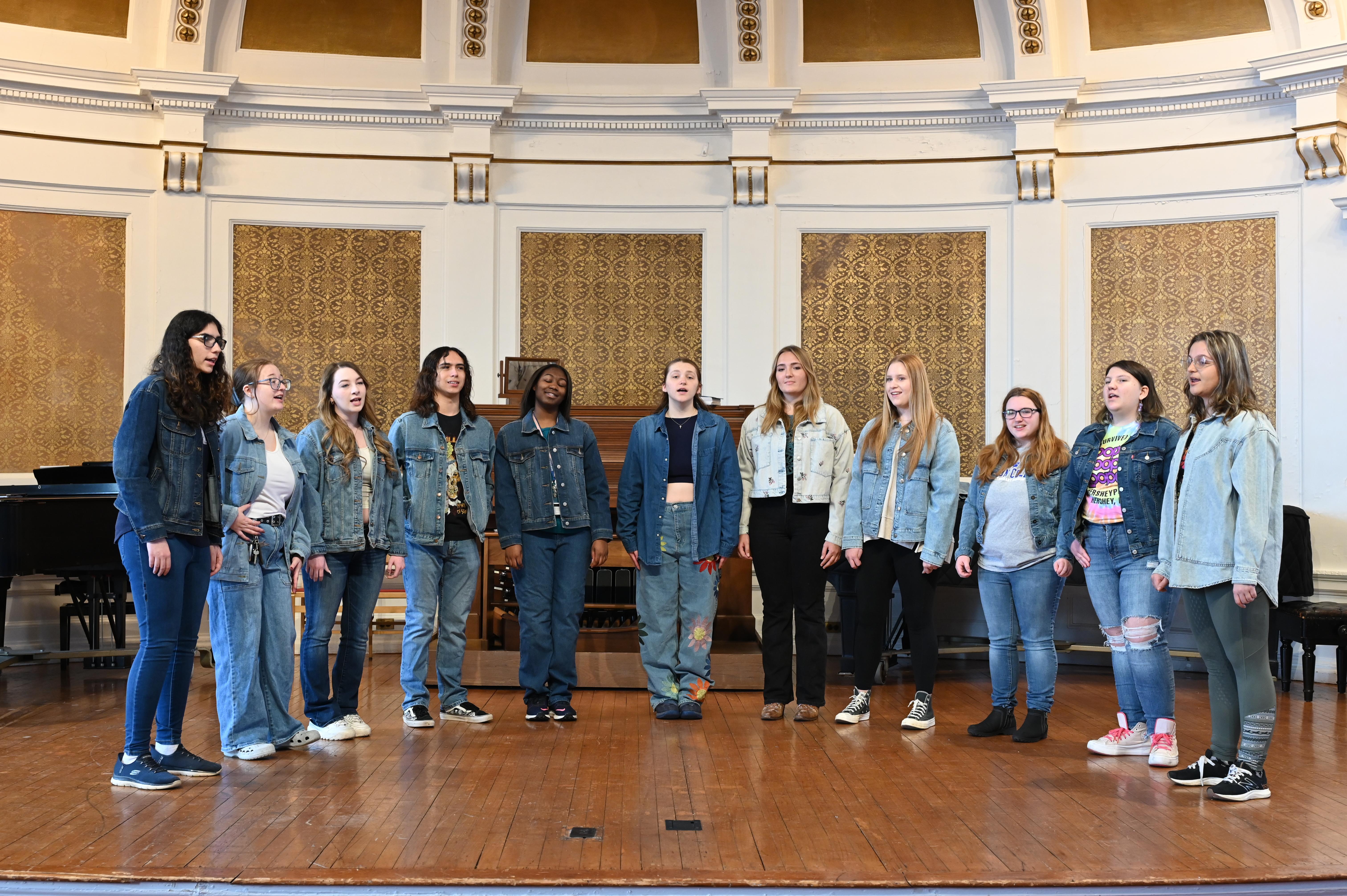 eleven students standing on stage singing - the Wilson College Ten Tones
