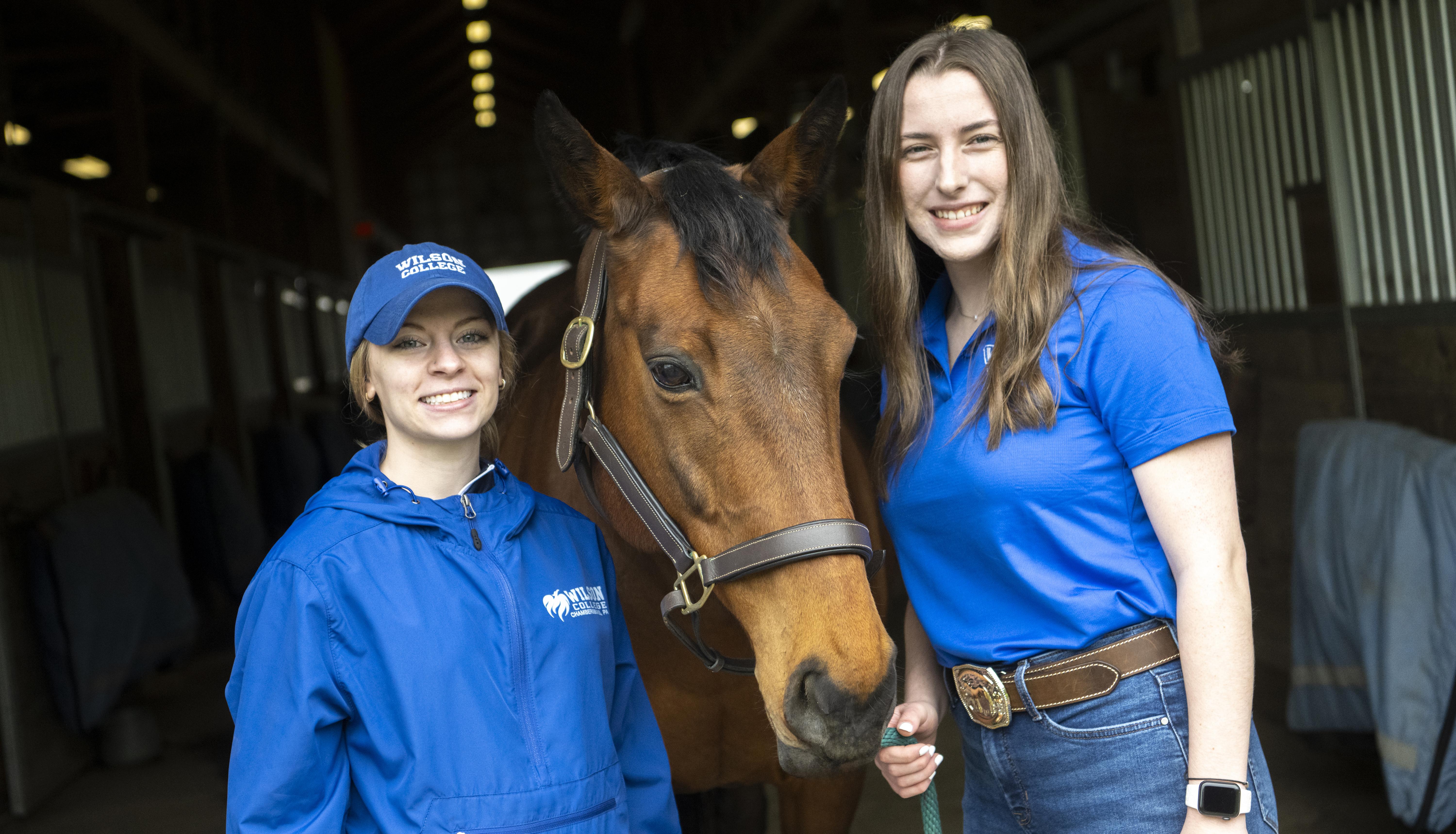 Two equestrian students and a horse